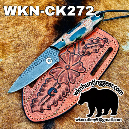 Close-up of a knife with a patterned handle resting on a pink tooled leather sheath on fur, with the bold code 'WKN-CK272' and a bear logo with an email address nearby.