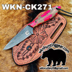 Fixed-blade knife on a carved pink leather sheath with a fur background; large 'WKN-CK271' text across the top.