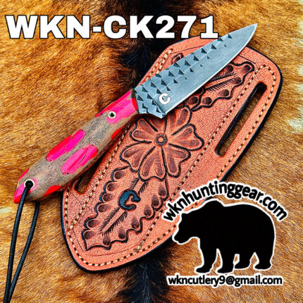 Close-up of a textured knife resting on a pink tooled leather sheath on fur, with bold 'WKN-CK271' text across the top.