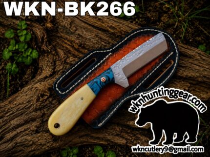 Fixed-blade knife with a blue-patterned handle resting in a brown leather sheath on a log; watermark shows wknhuntinggear.com in the corner.
