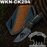 Damascus knife with blue leather sheath on soil, woven brown panel and white top text reading 'WKN-CK294'; watermark logo 'wkncutlery9' at bottom right.