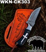 Damascus knife with a patterned blade in an orange leather sheath outdoors; logo and contact info visible in the corner (wkn hunting gear).