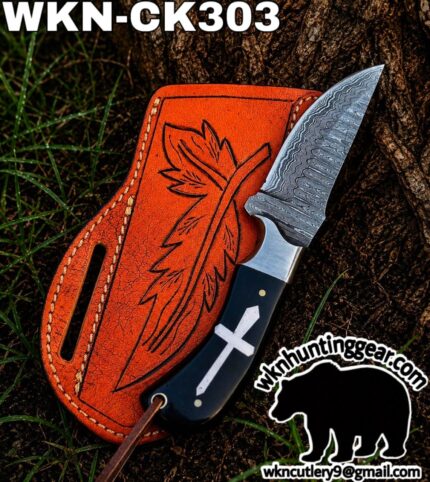 Damascus knife with a patterned blade in an orange leather sheath outdoors; logo and contact info visible in the corner (wkn hunting gear).