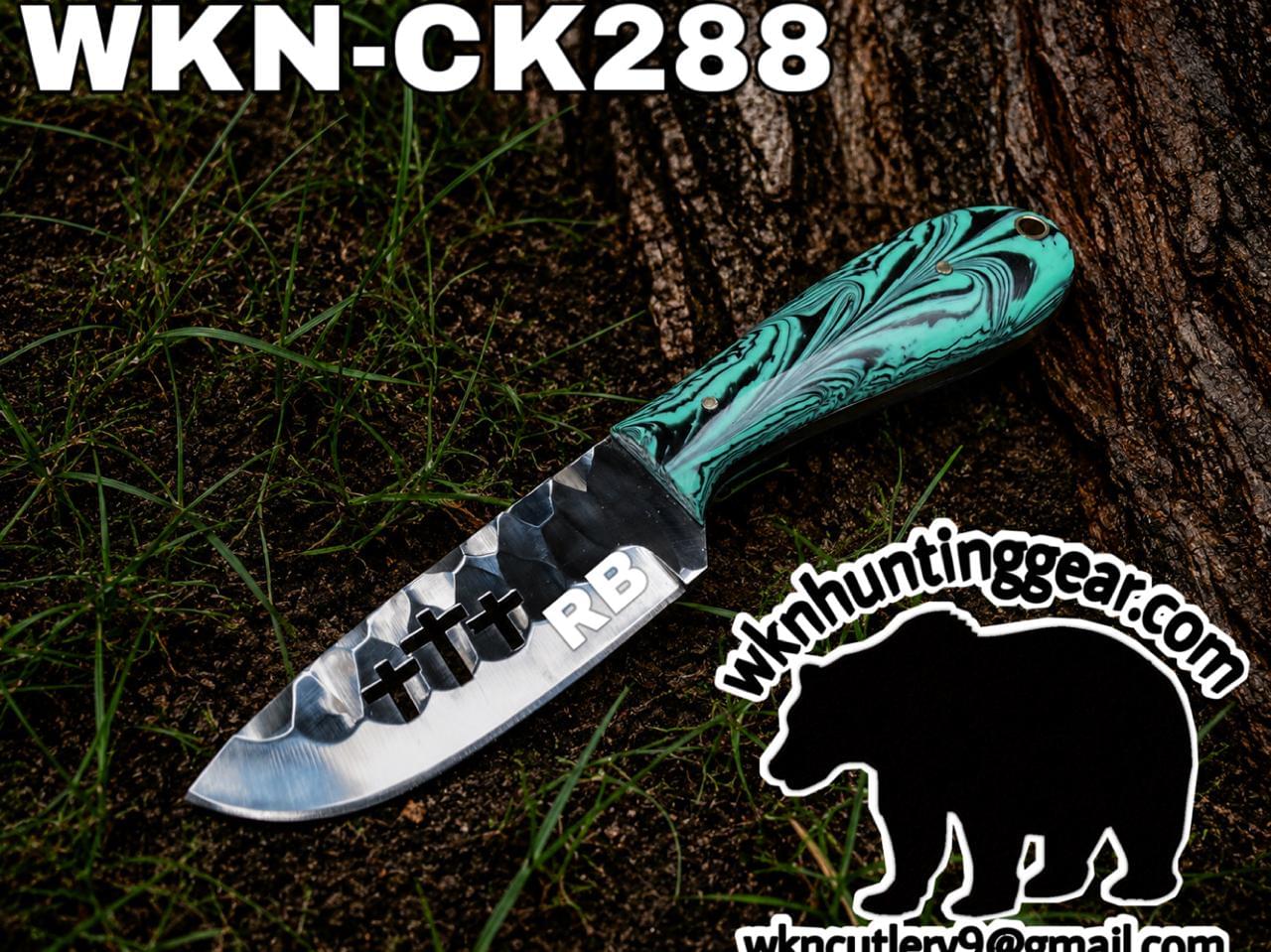 Damascus-style knife with a teal marbled handle resting against a tree, labeled WKN-CK288, with a bear logo and huntinggear watermark bottom right.
