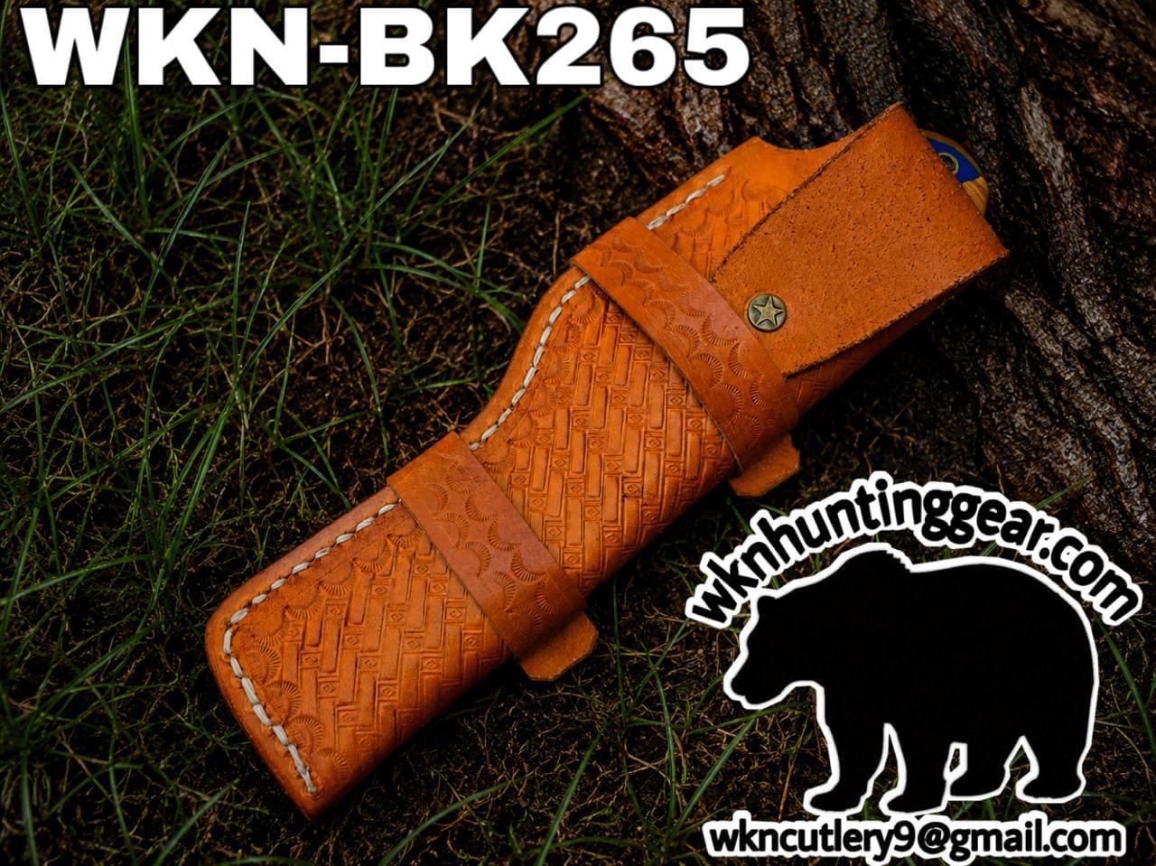 Brown tooled leather knife sheath on grass, model WKN-BK265, with WKNCutlery logo watermark nearby.
