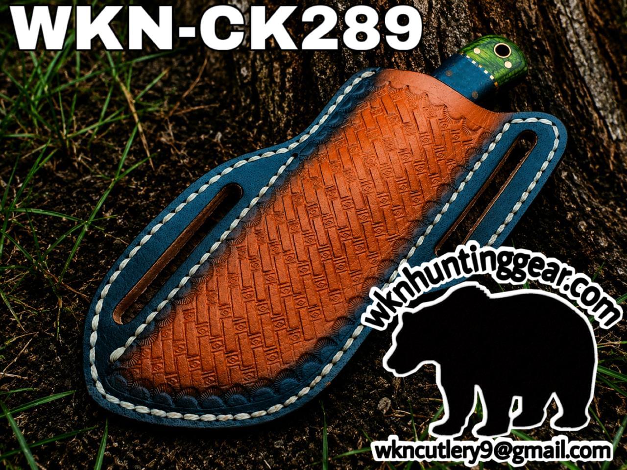Blue-edged leather knife sheath with an orange tooled center and a green handle peeking out; watermark reads WKNC Hunting Gear with a bear logo.