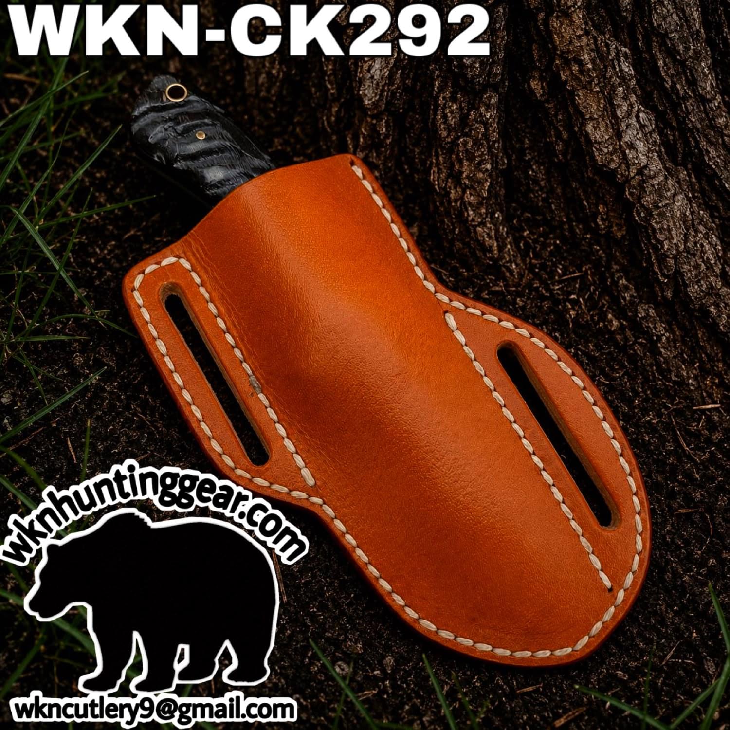 Orange leather knife sheath with white stitching, a portion of a black knife handle peeking out, set outdoors beside a tree; visible branding reads WKN-CK292