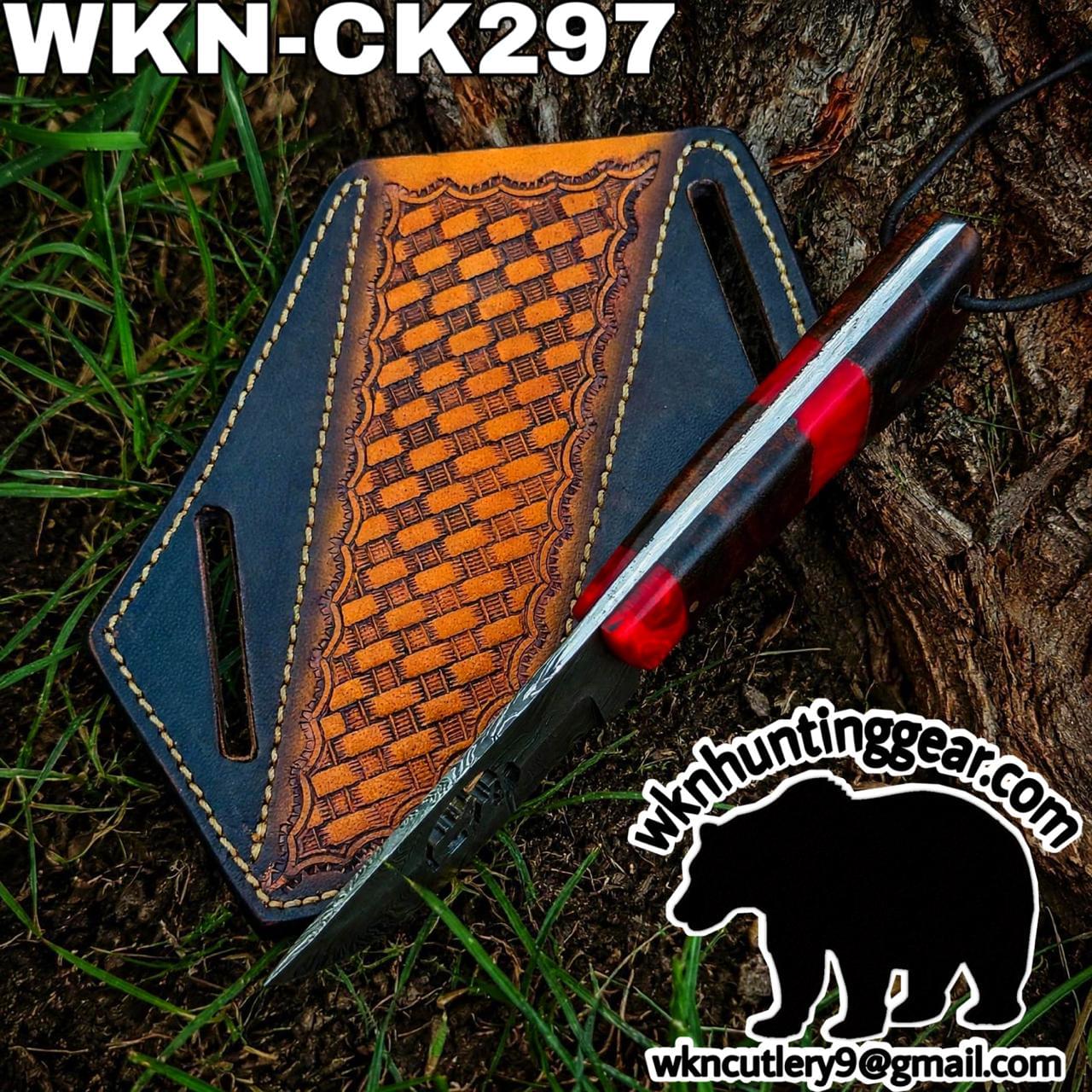 Leather knife sheath with orange basketweave pattern lying on grass next to a red- and black-handled knife; branding for wknhuntinggear visible.