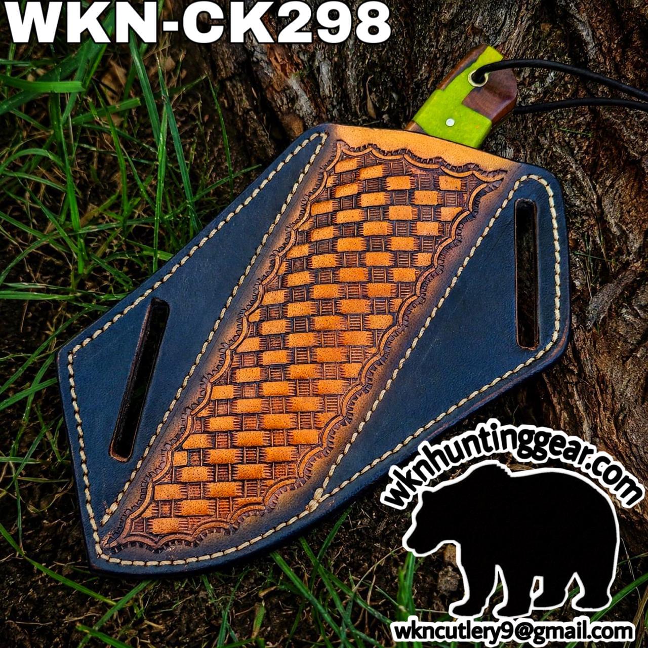 Leather knife sheath with a tan woven panel on blue leather, resting on a tree trunk; green blade handle protrudes from the top, watermark logo in corner.