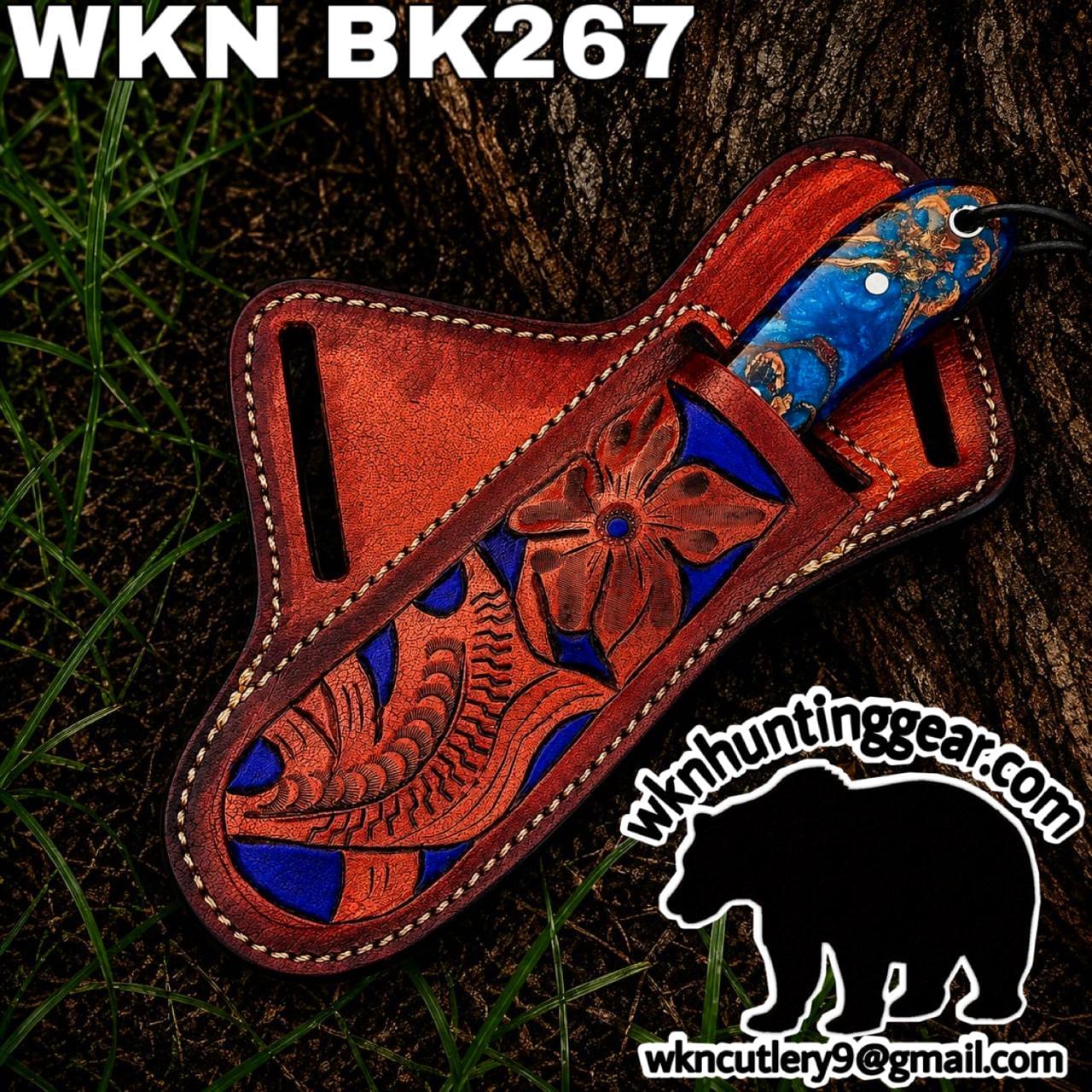 Decorative tooled leather knife sheath with blue-red floral design and a blue-handled knife.