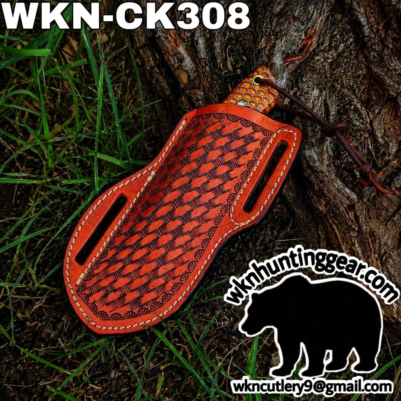 Red tooled leather knife sheath with woven pattern, tied to a tree trunk; branding text visible in corner.